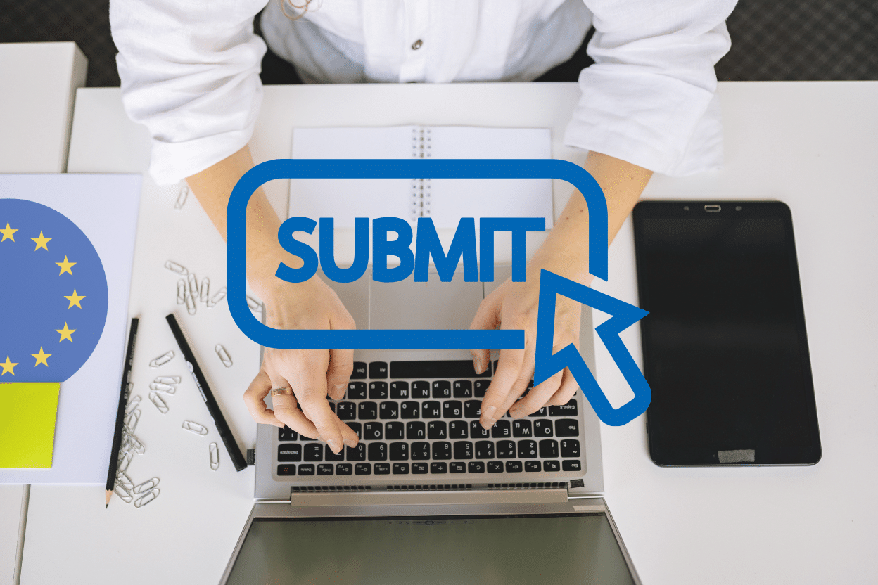 A person typing on a laptop to submit an Erasmus+ KA121 accreditation application, featuring a blue "Submit" button icon and the European Union flag symbol on the desk.